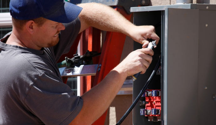 Person repairing an electrical system