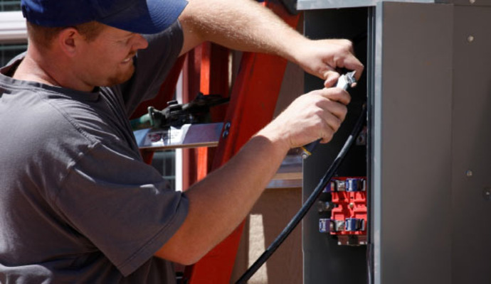 Professional repairing a generator using specialized tools