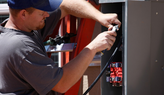 Expert repairing a generator using tools