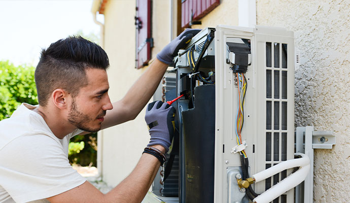 Technician repairing generator using tools