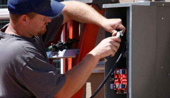 Technician repairing electrical box